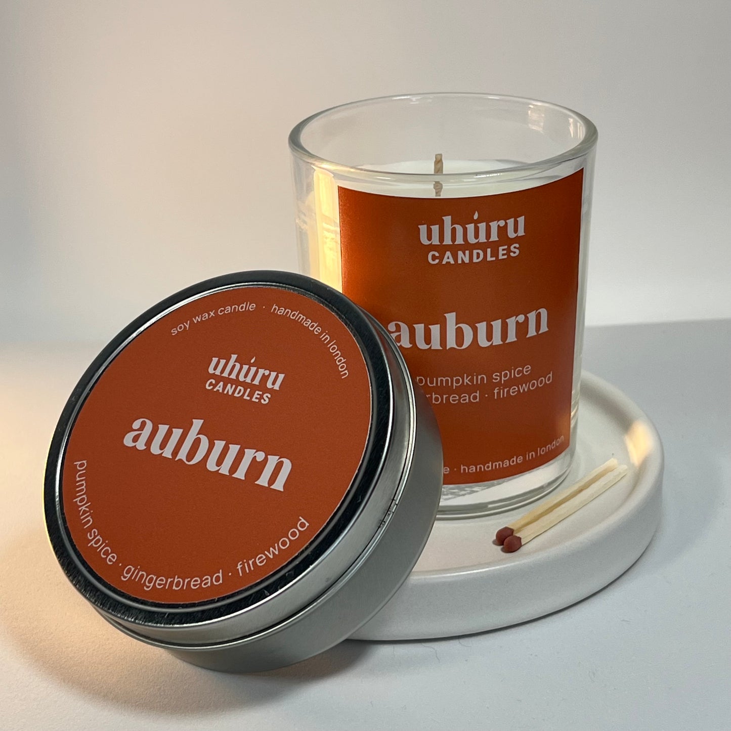 Uhuru Candles Auburn candle with lid on a white surface