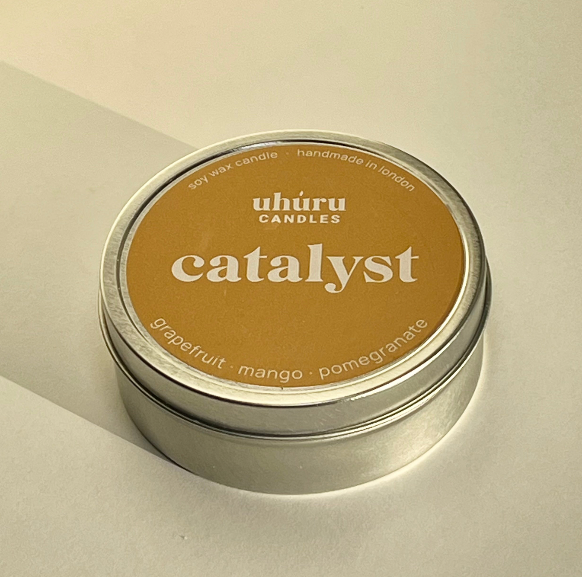 Catalyst by Uhuru Candles - grapefruit, mango and pomegranate scented soy wax candle in tin container. Net weight 70g.