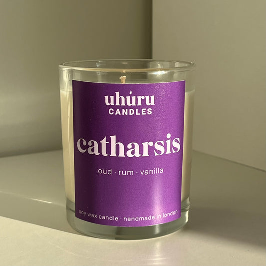 Catharsis by Uhuru Candles - oud, rum and vanilla scented soy wax candle in glass jar container. Net weight 150g.