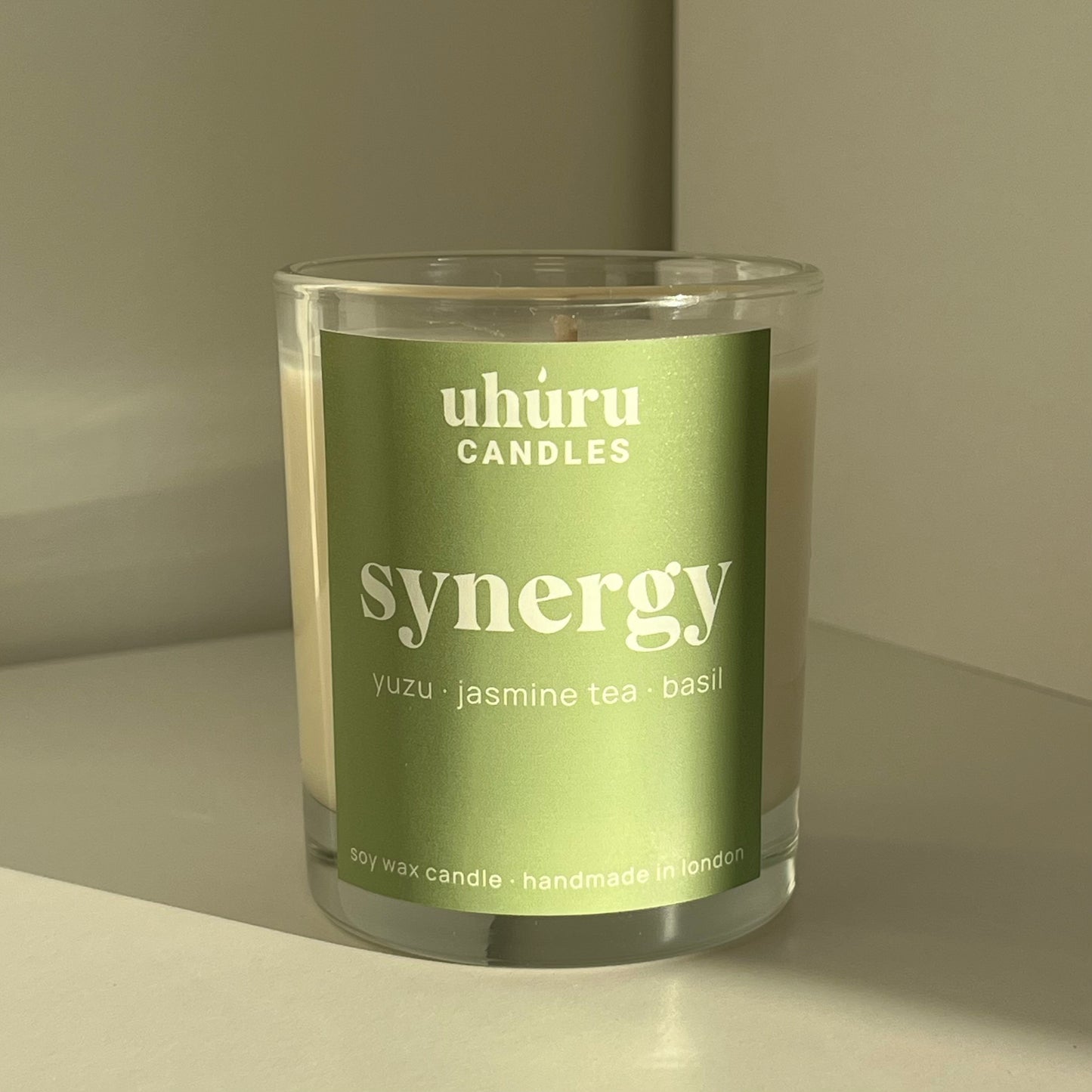 Synergy by Uhuru Candles - yuzu, jasmine tea and basil scented soy wax candle in glass container. Jar net weight 150g.