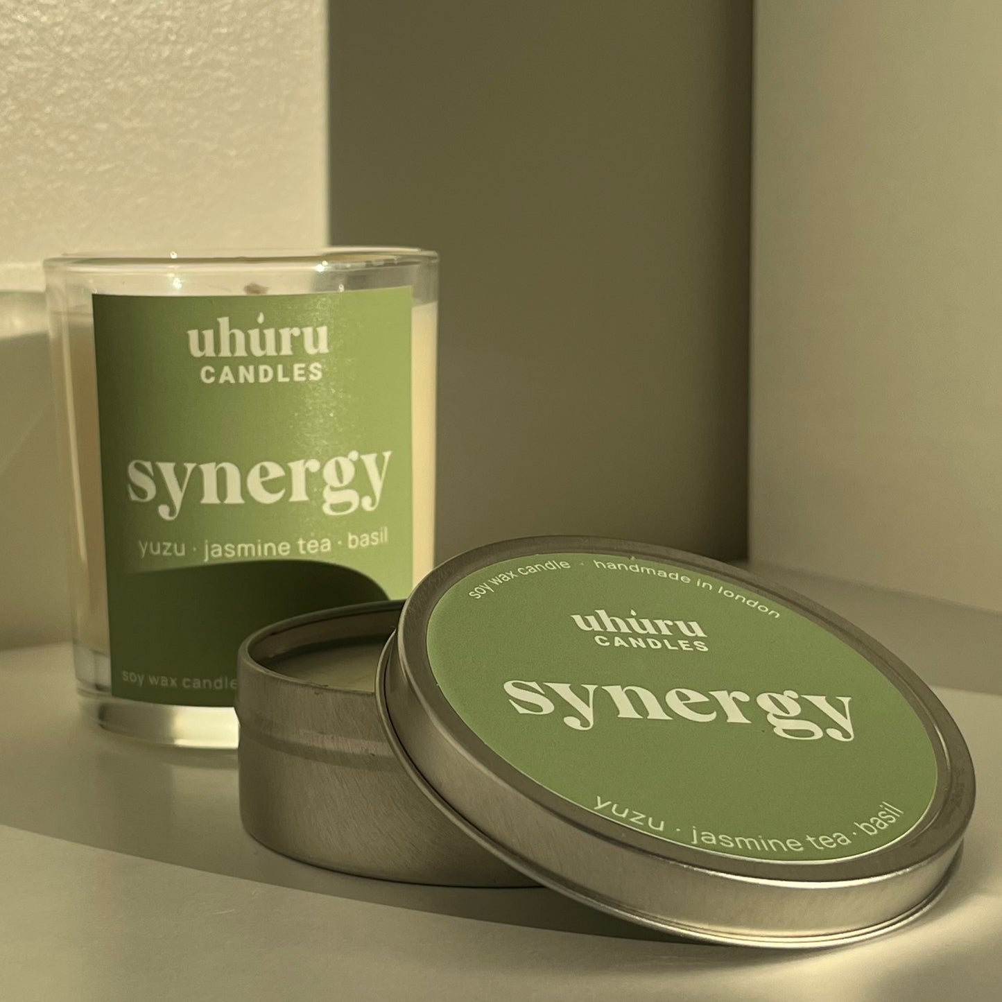 Synergy by Uhuru Candles - yuzu, jasmine tea and basil scented soy wax candle in glass jar container and metal tin. Jar net weight 150g. Tin net weight 70g.